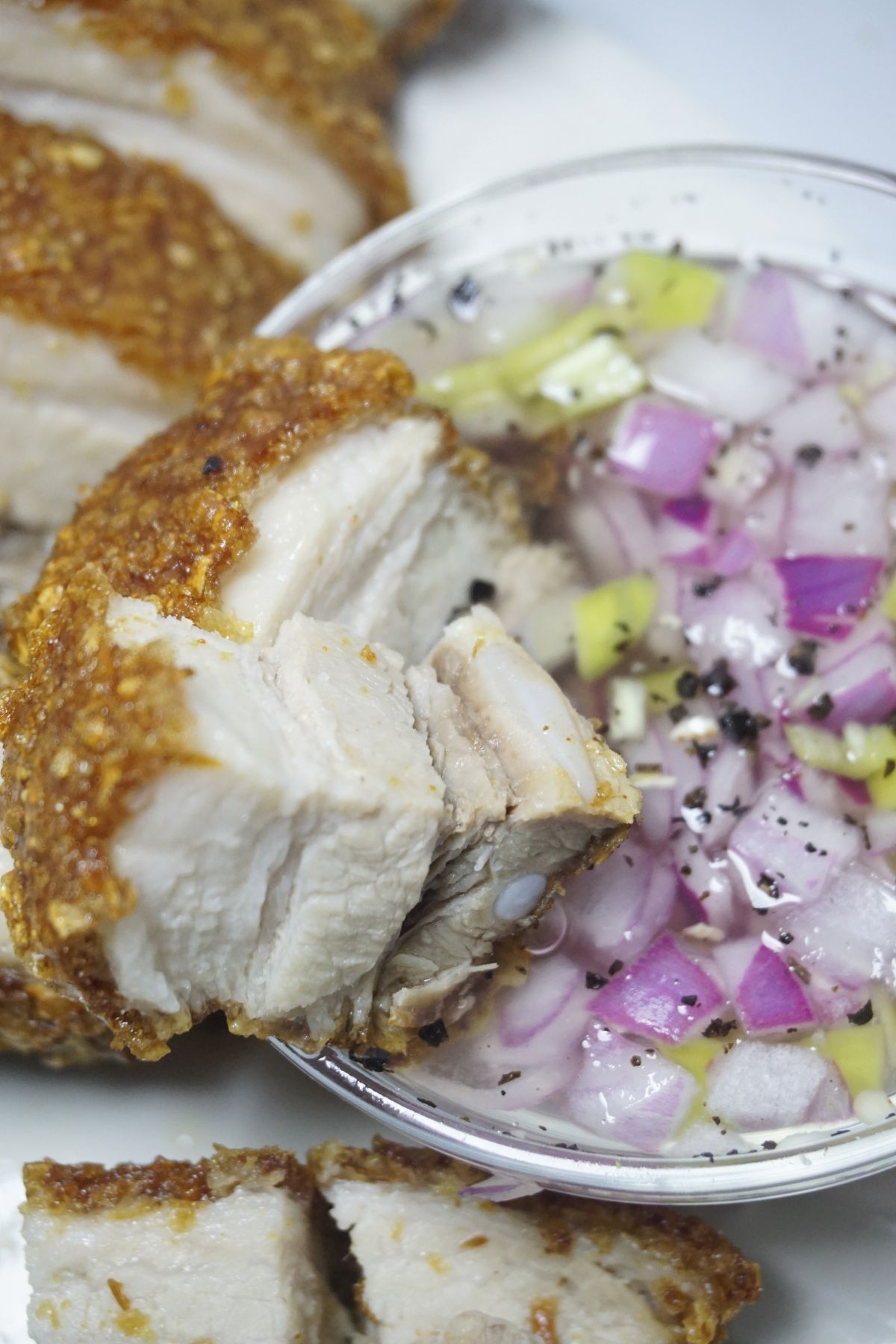 Crispy lechon kawali slice in a vingegar dip