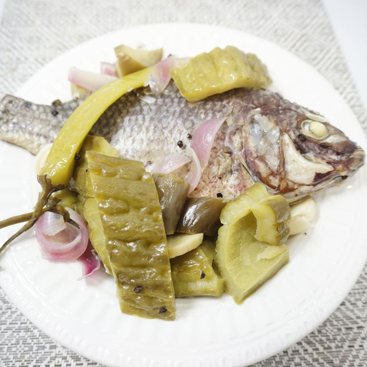 A serving of paksiw na tilapia in plate.
