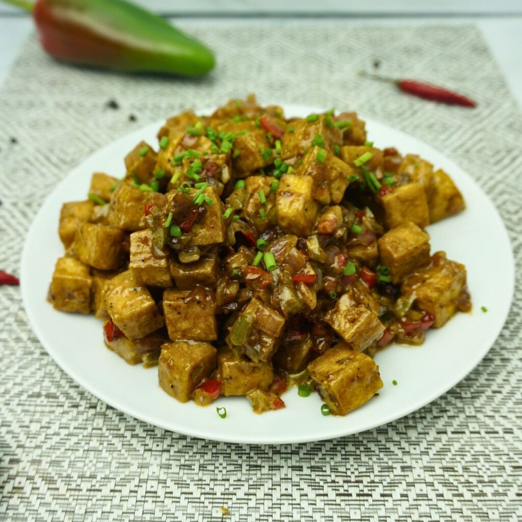 Tofu Sisig garnished with chop green onions.