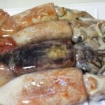 Fresh squid in a white plastic plate.