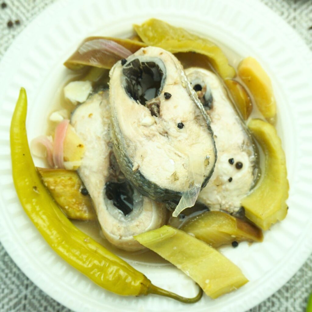 Paksiw na bangus slices with vegetables served in a plate.
