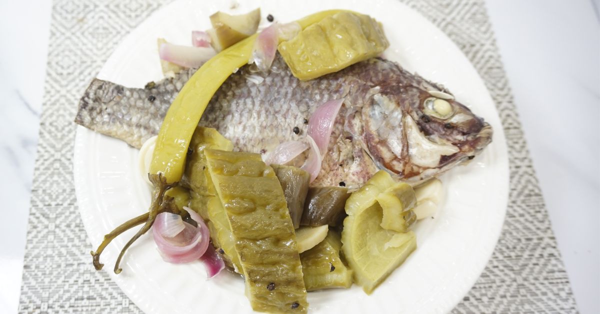 Paksiw na tilapia serving in a white plate.