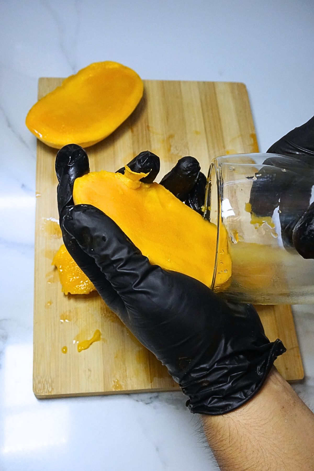 Ripe mango fleshed out using a glass