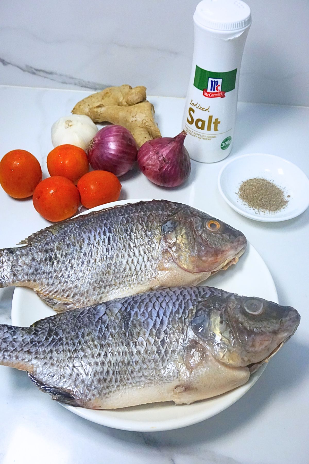Clean tilapia, tomato, onion, garlic, ginger,salt and pepper