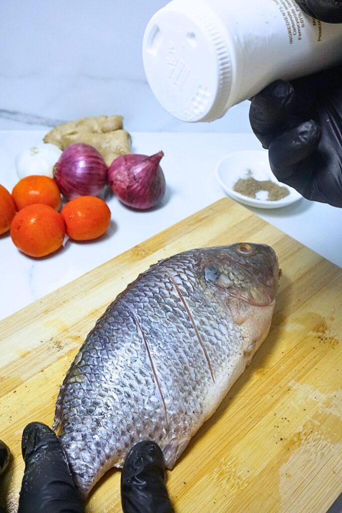 Fresh tilapia season with salt and pepper