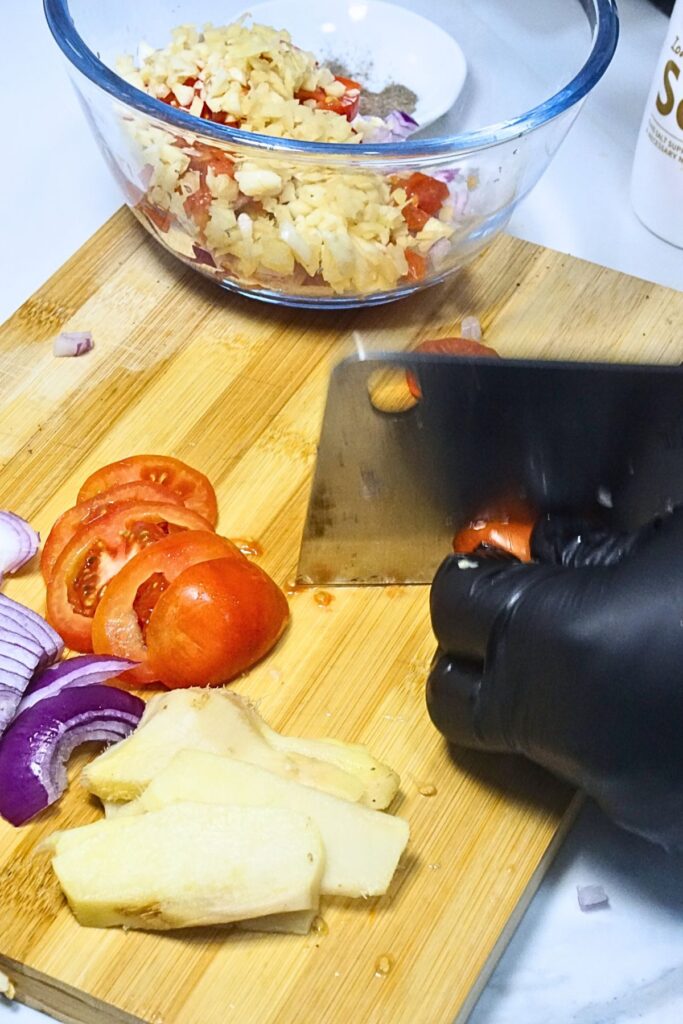 Slicing tomato, garlic, onion and ginger