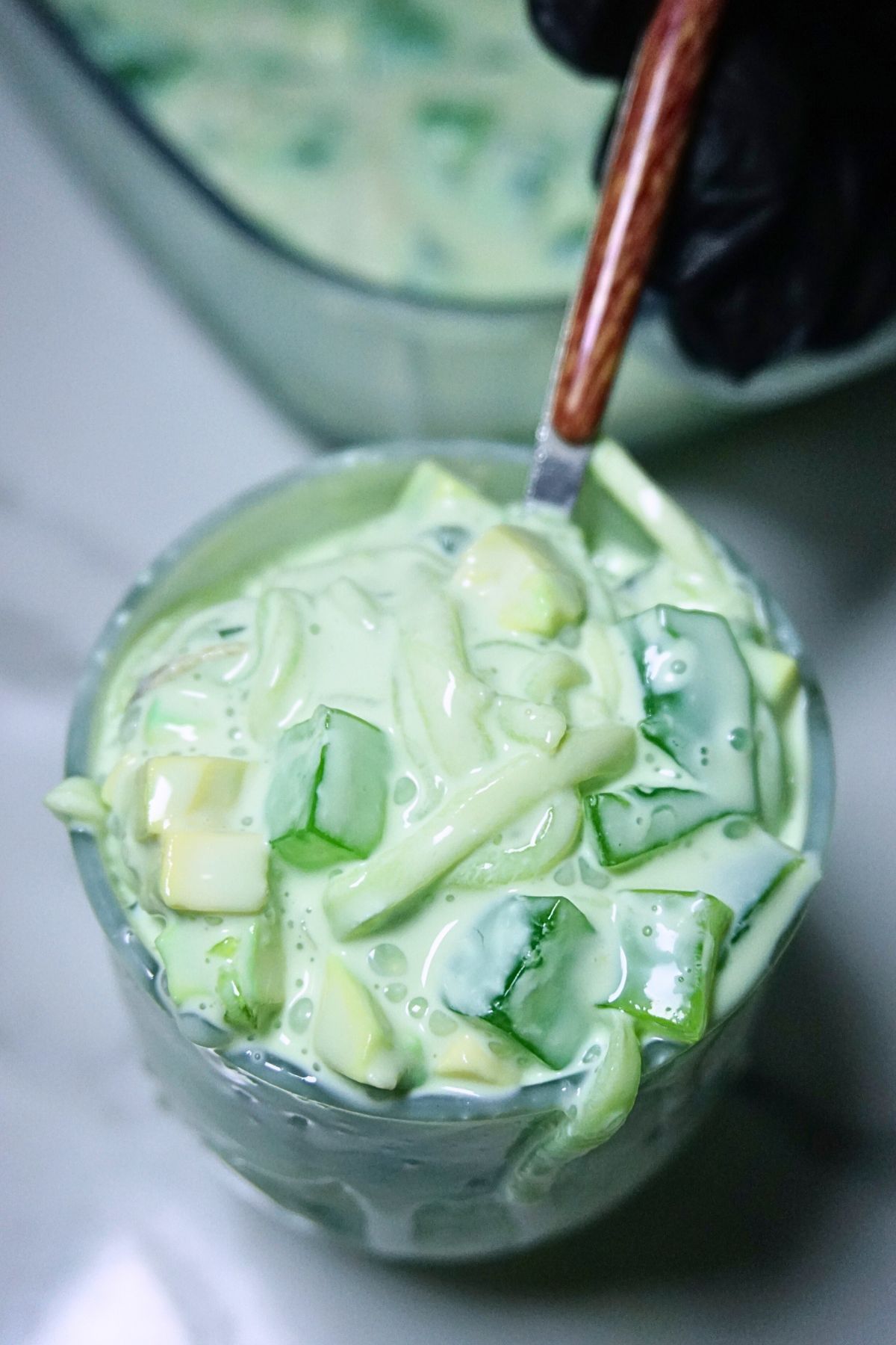 Creamy buko pandan salad served in a glass cup