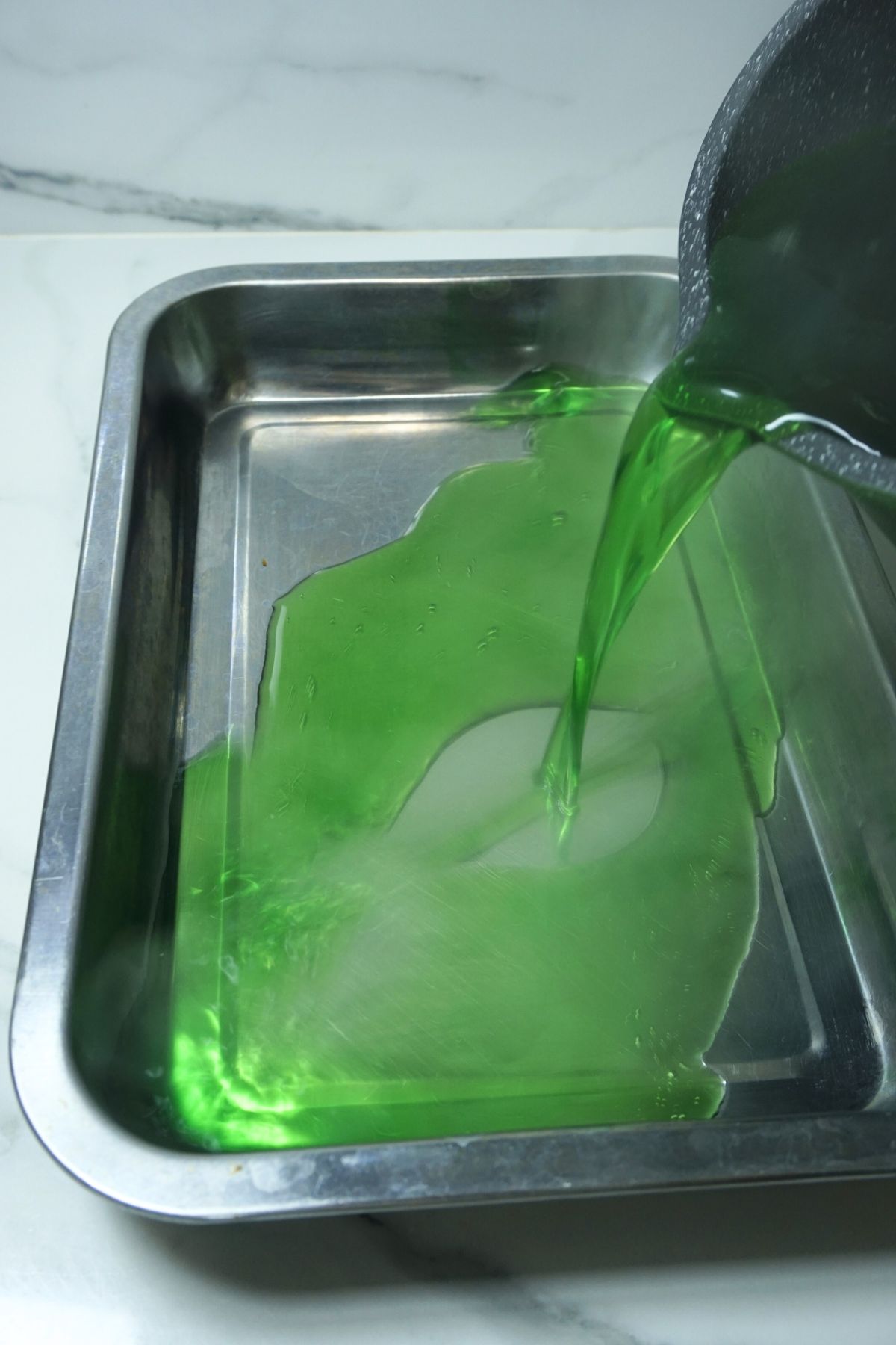 Pouring cooked gelatin mix in a moulding tray