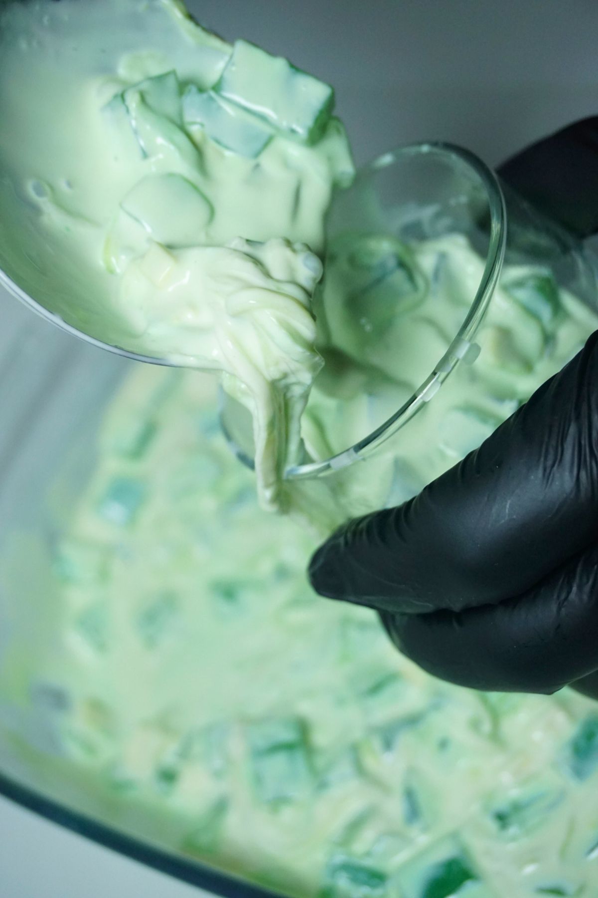 Pouring chilled buko pandan salad in a glass