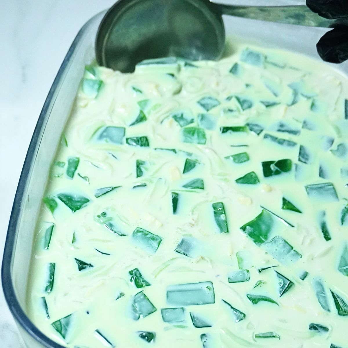 Chilled buko pandan salad in a glass baking dish