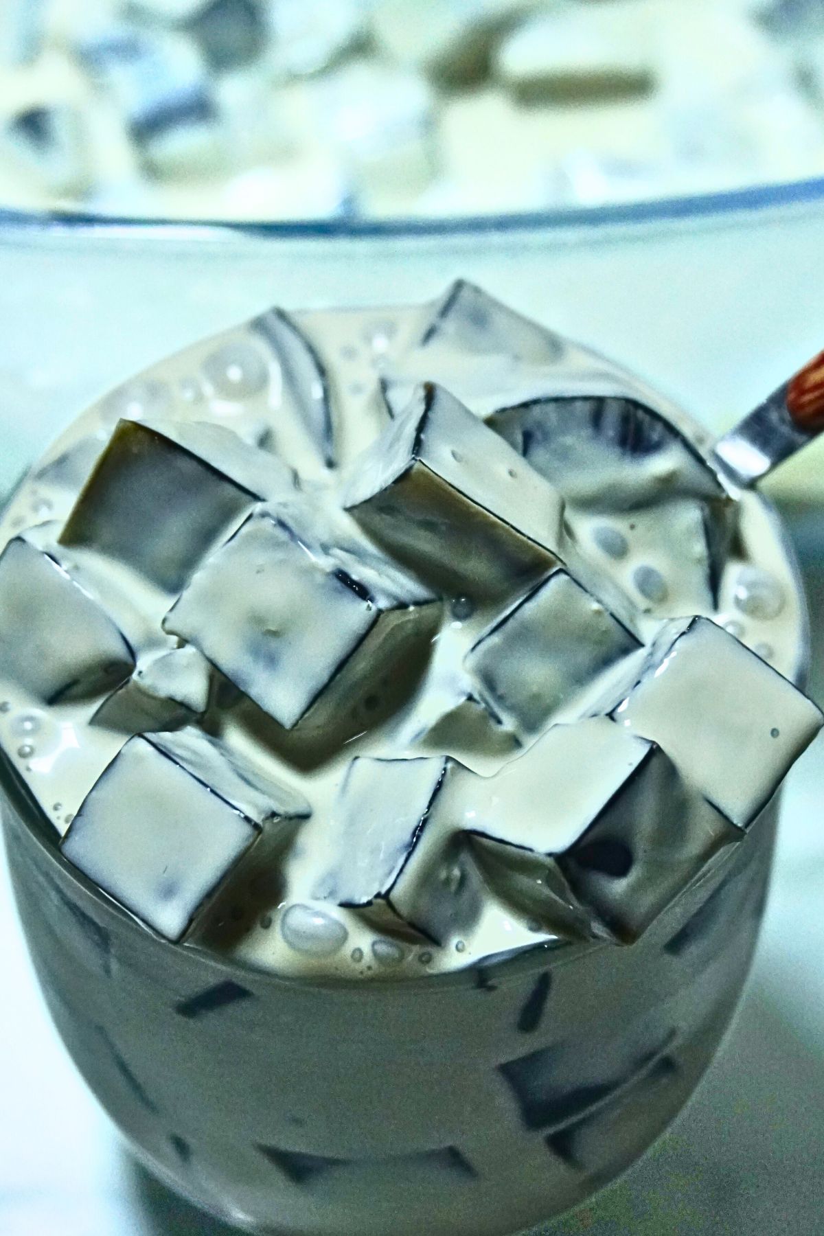 A serving of creamy coffee jelly in a glass cup