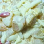 A serving of creamy fruit salad in a small plate