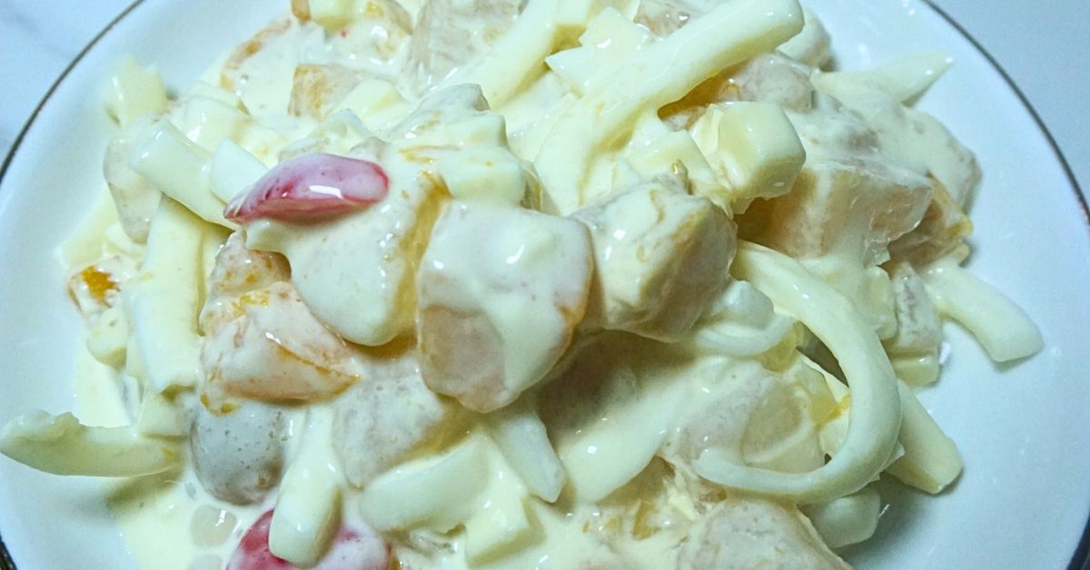 A serving of creamy fruit salad in a small plate