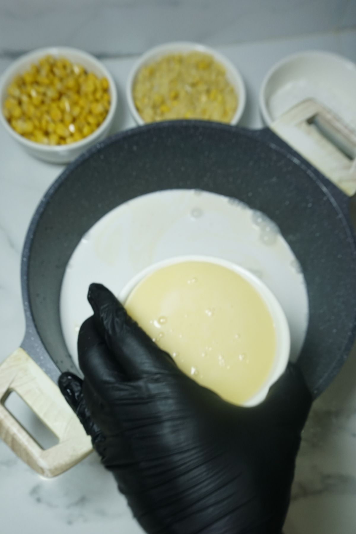 Coconut milk and condensed milk mix in a pot