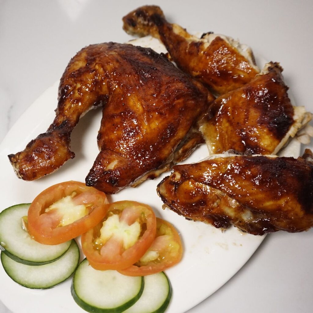 Sliced chicken bbq served on a white plate