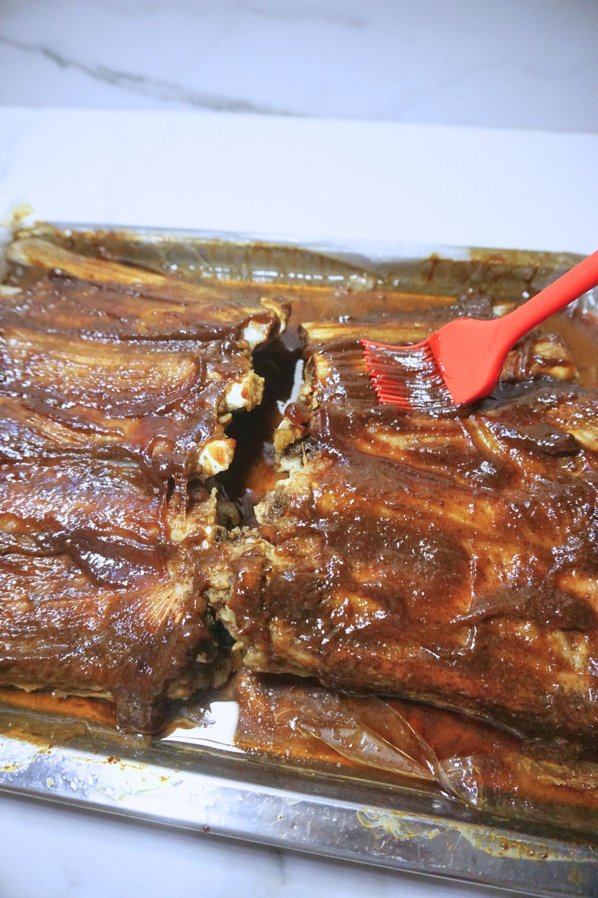 Bbq pork ribs brushed with sauce.