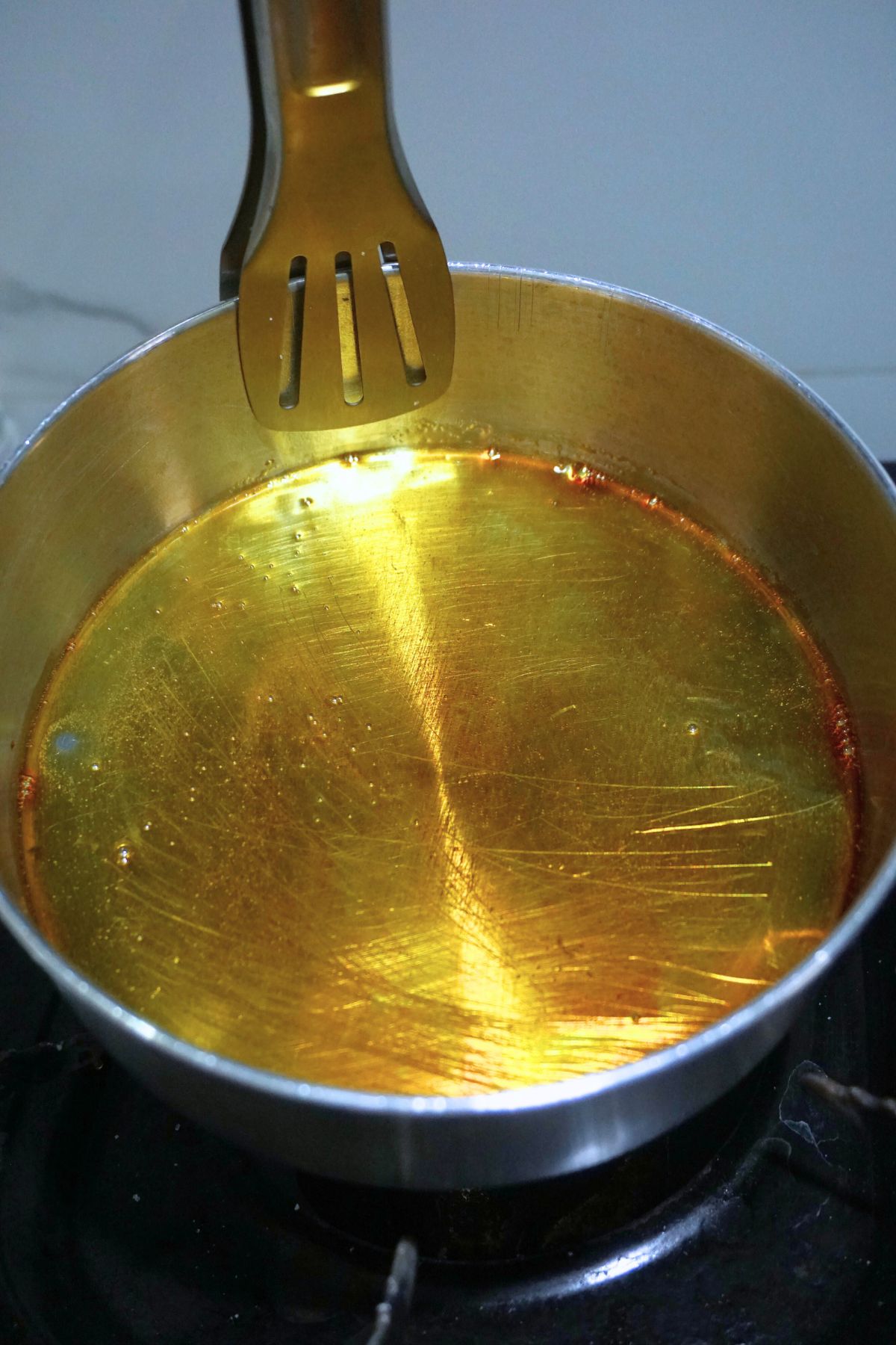 Sugar melted in a llanera on top of stove.