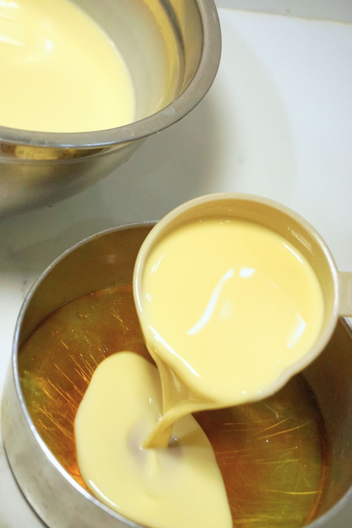 Leche flan mixture transferred to mold with caramelized sugar