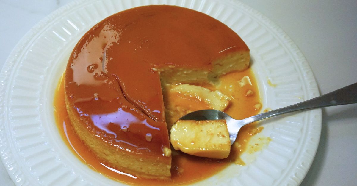 Leche flan in a white plate, portion slice.