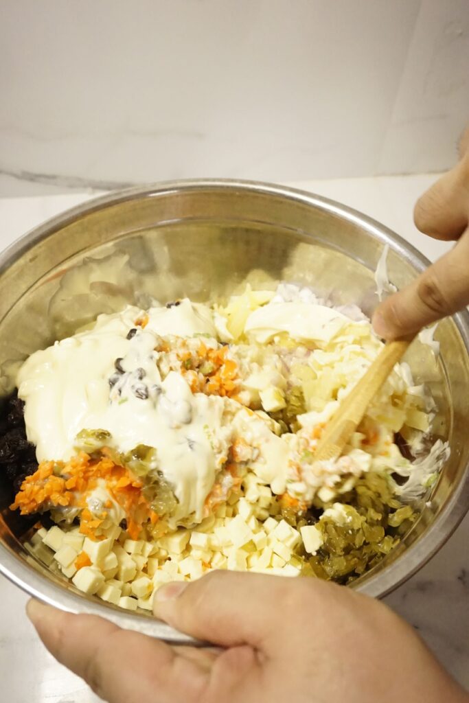 Macaroni salad mixed in a metal bowl