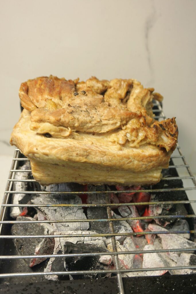 Grilled pork over charcoal